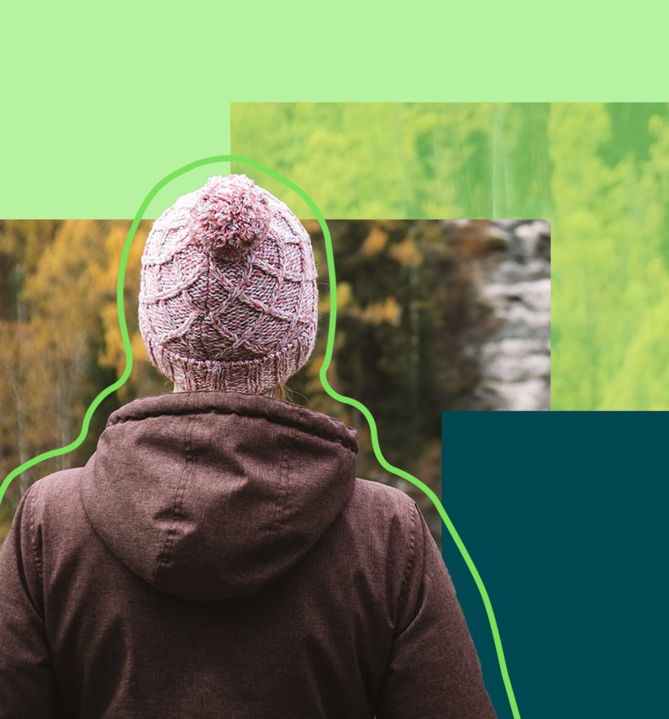 A person in a jacket and hat facing away.