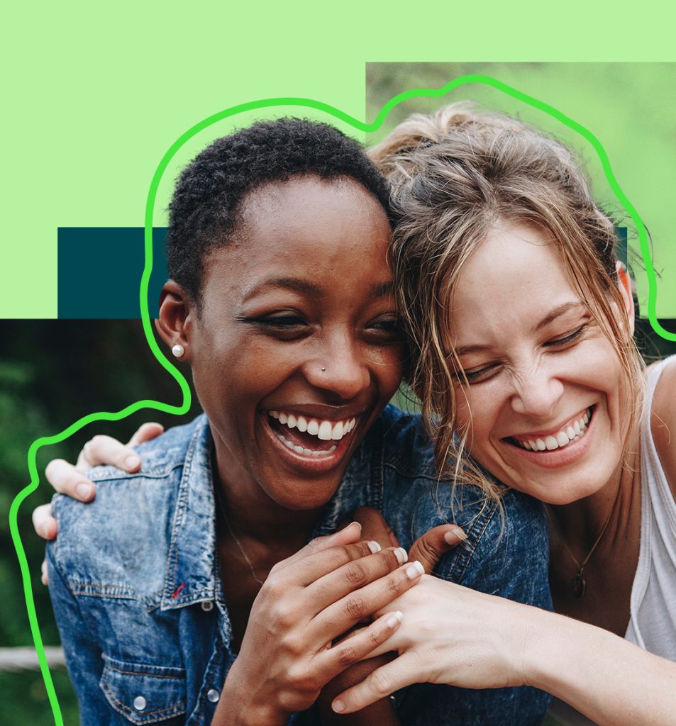 Two people laughing and embracing.