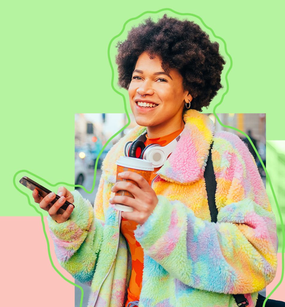 A person holding a phone and their coffee cup smiling.