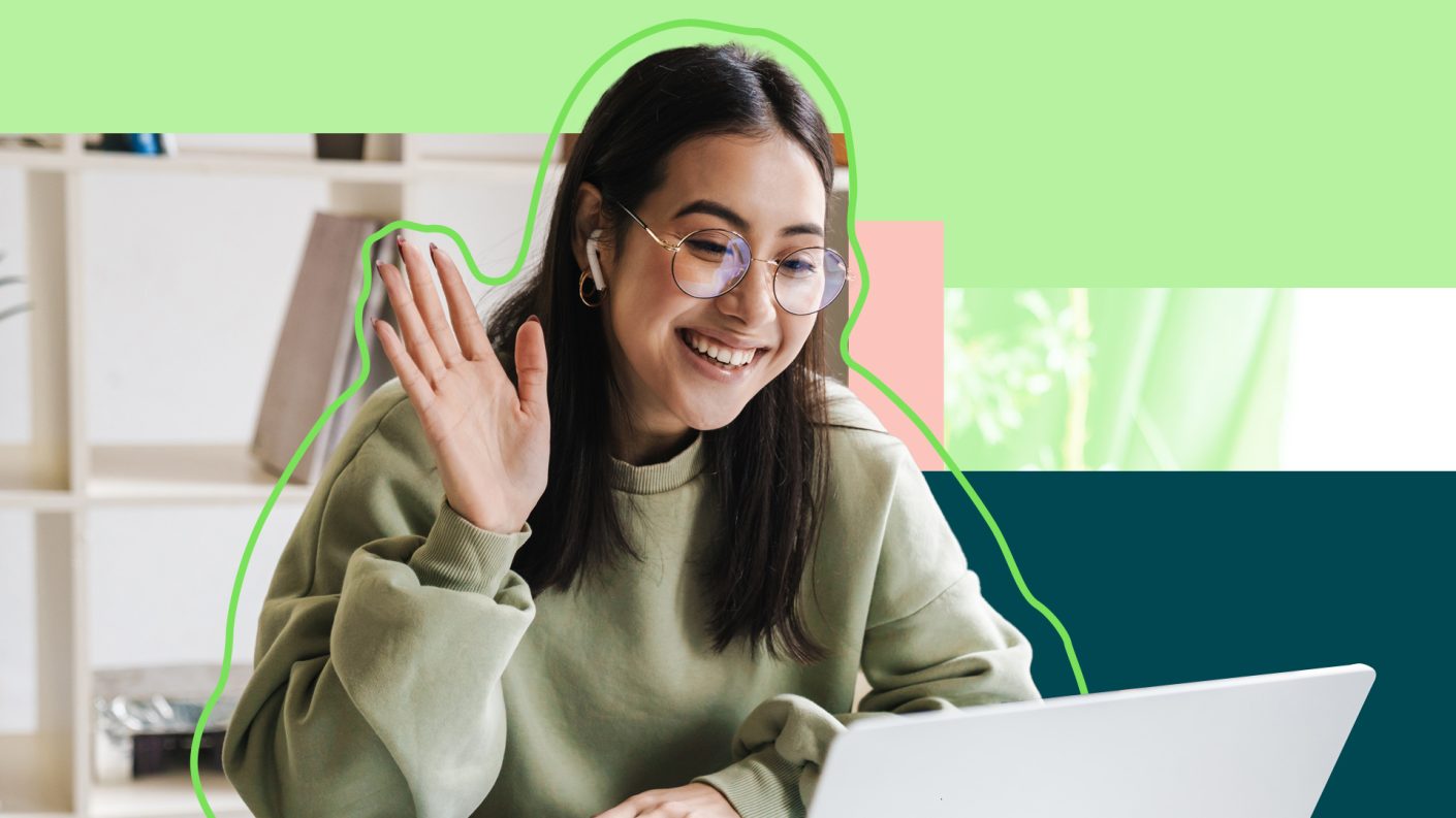 A person smiling and waving on a laptop call