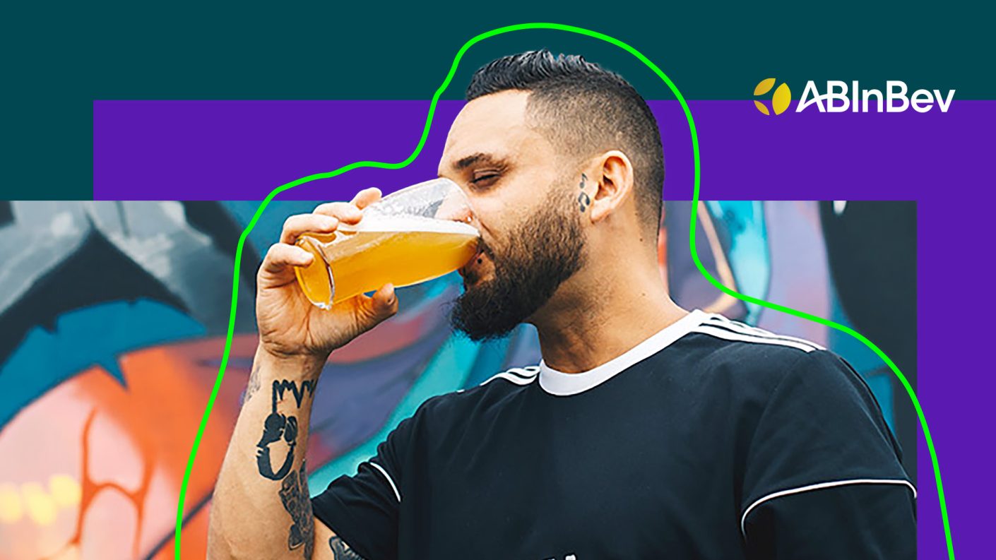 A person drinking from a pint glass