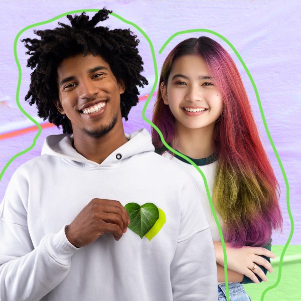 Young man and woman laughing , with a leaf on the chest hinting to sustainability