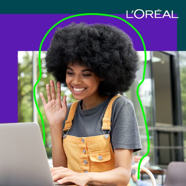 Woman smiling and waving at her laptop screen