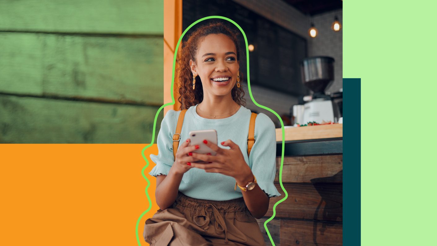 Young woman holding phone and smiling