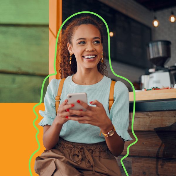 Young woman holding phone and smiling