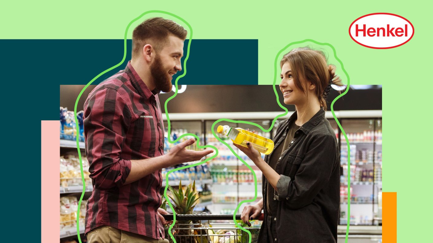 Two people discussin in supermarket, one holding a bottle