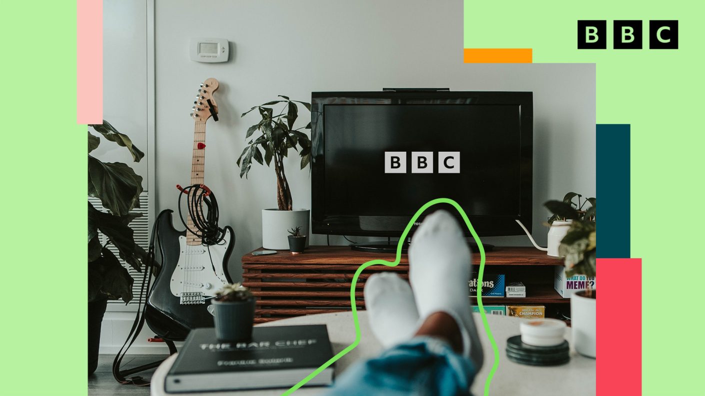 Feet of person watching tv