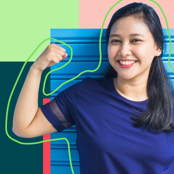 Woman in blue T-shirt flexes arm