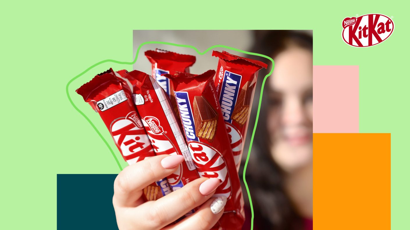 Woman holding KitKat bars