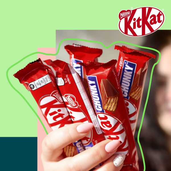 Woman holding KitKat bars