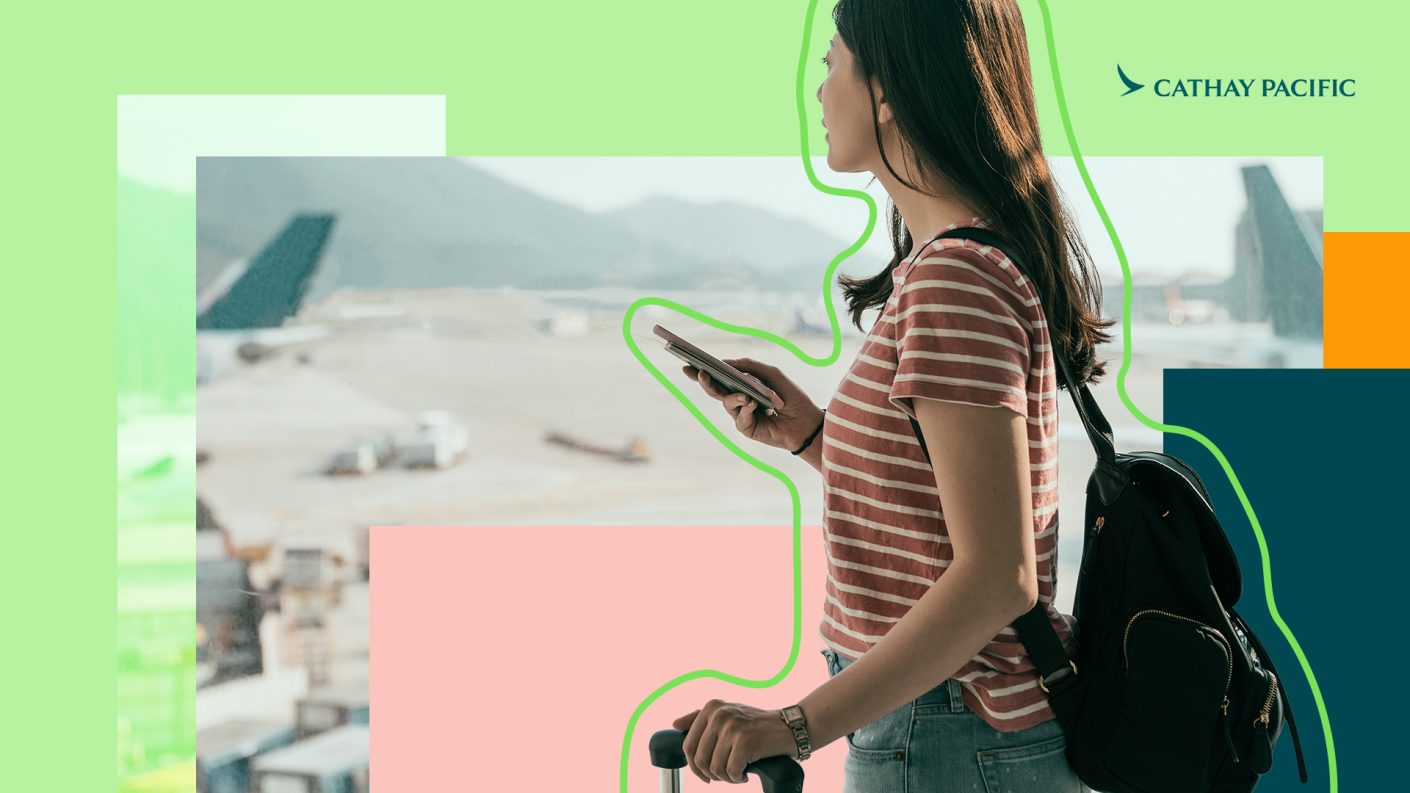 Young woman with smartphone in hand travelling