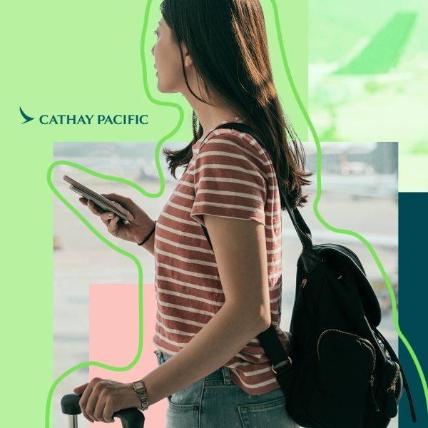 Young woman with smartphone in hand travelling