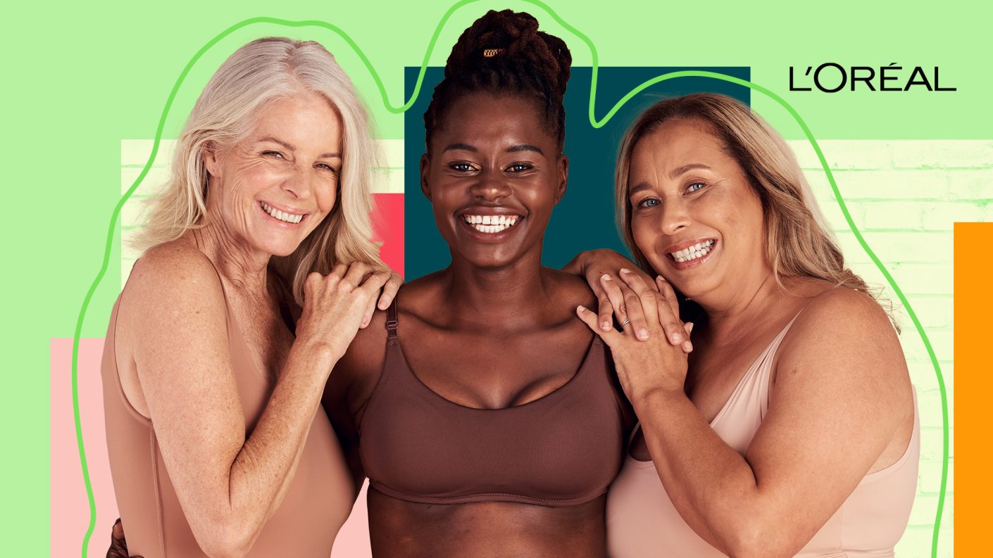 Three woman having their arms around each other and looking into the camera