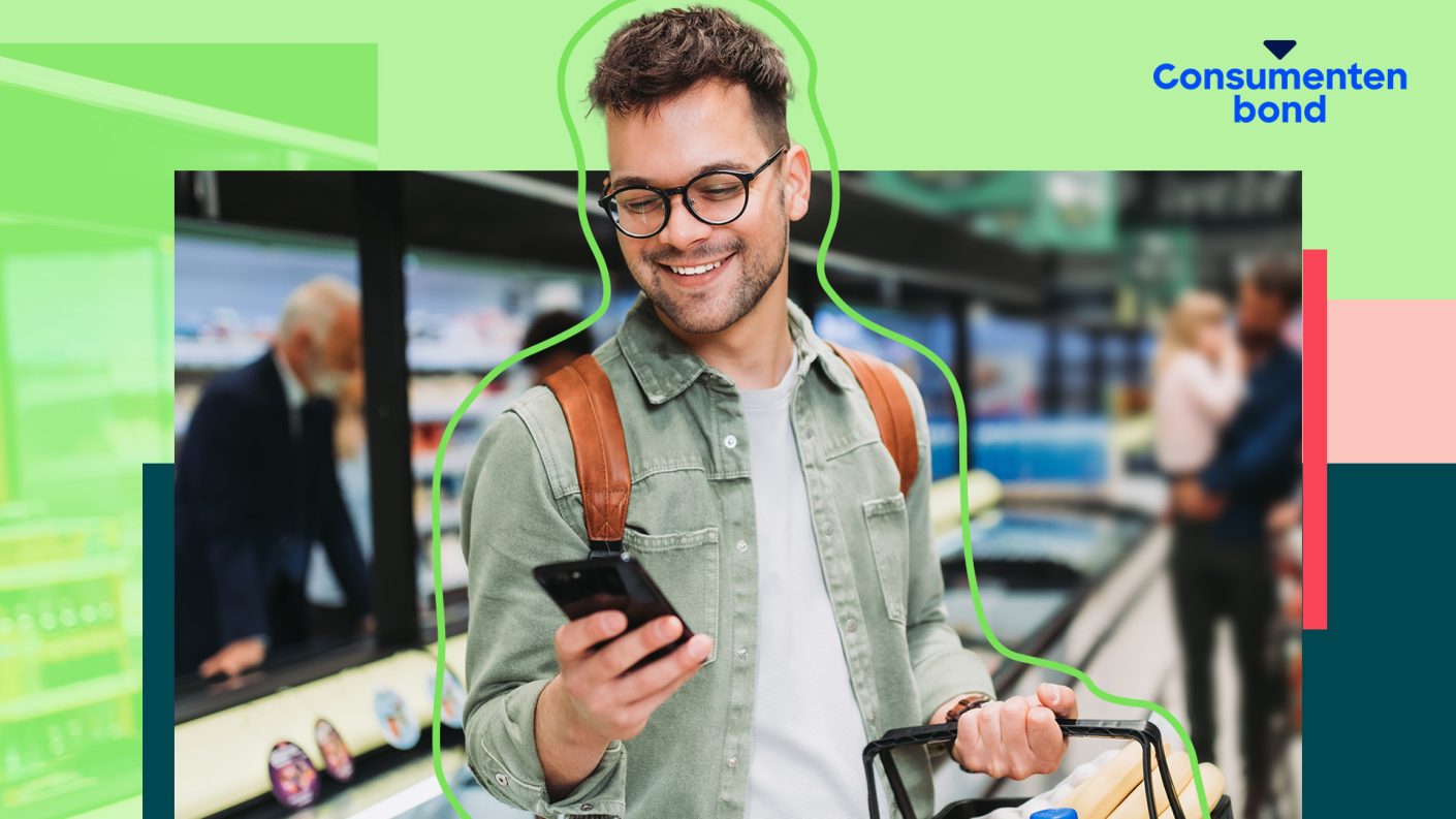 Young man in the supermarket holding his phone