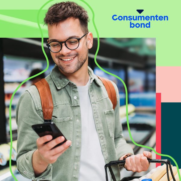 Young man in the supermarket holding his phone