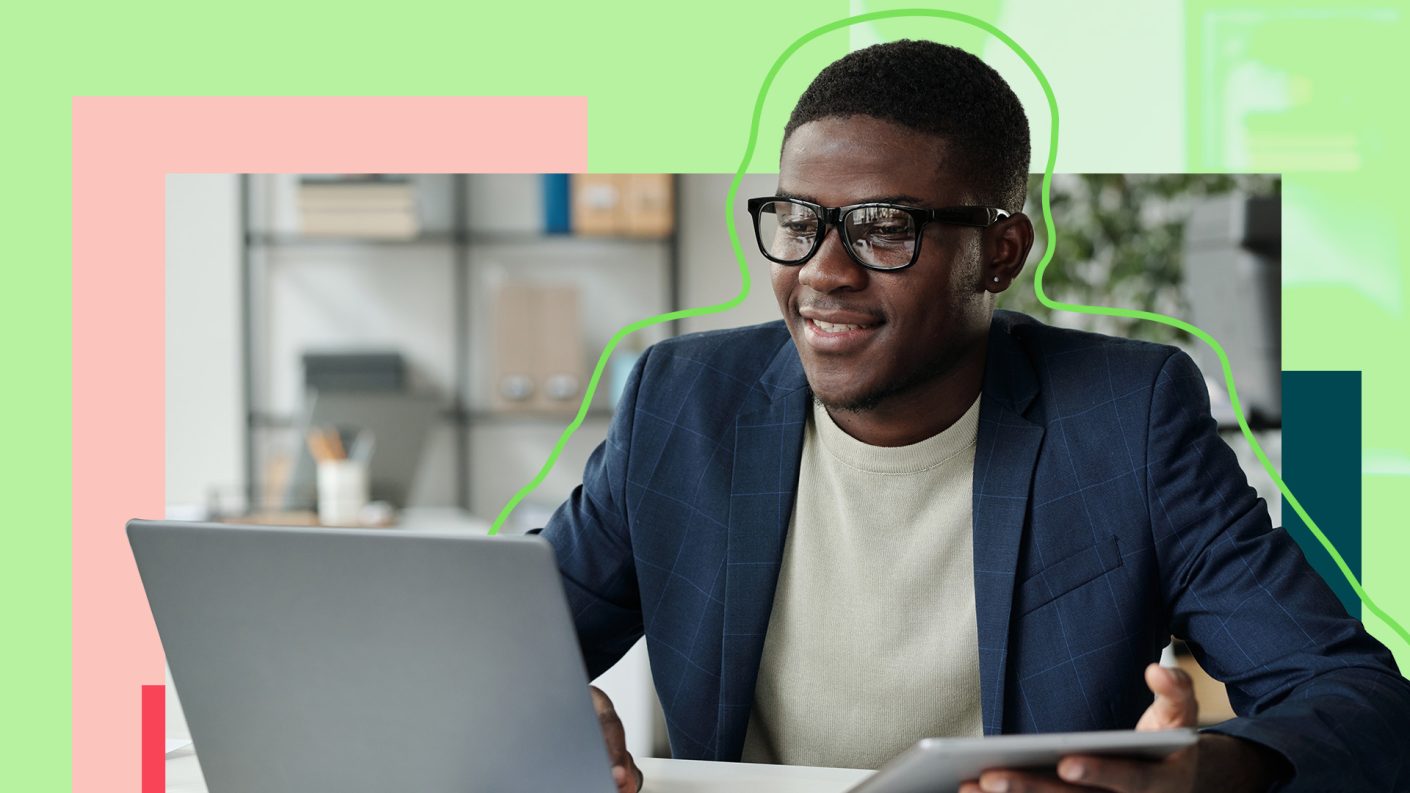 Man with glasses on open laptop