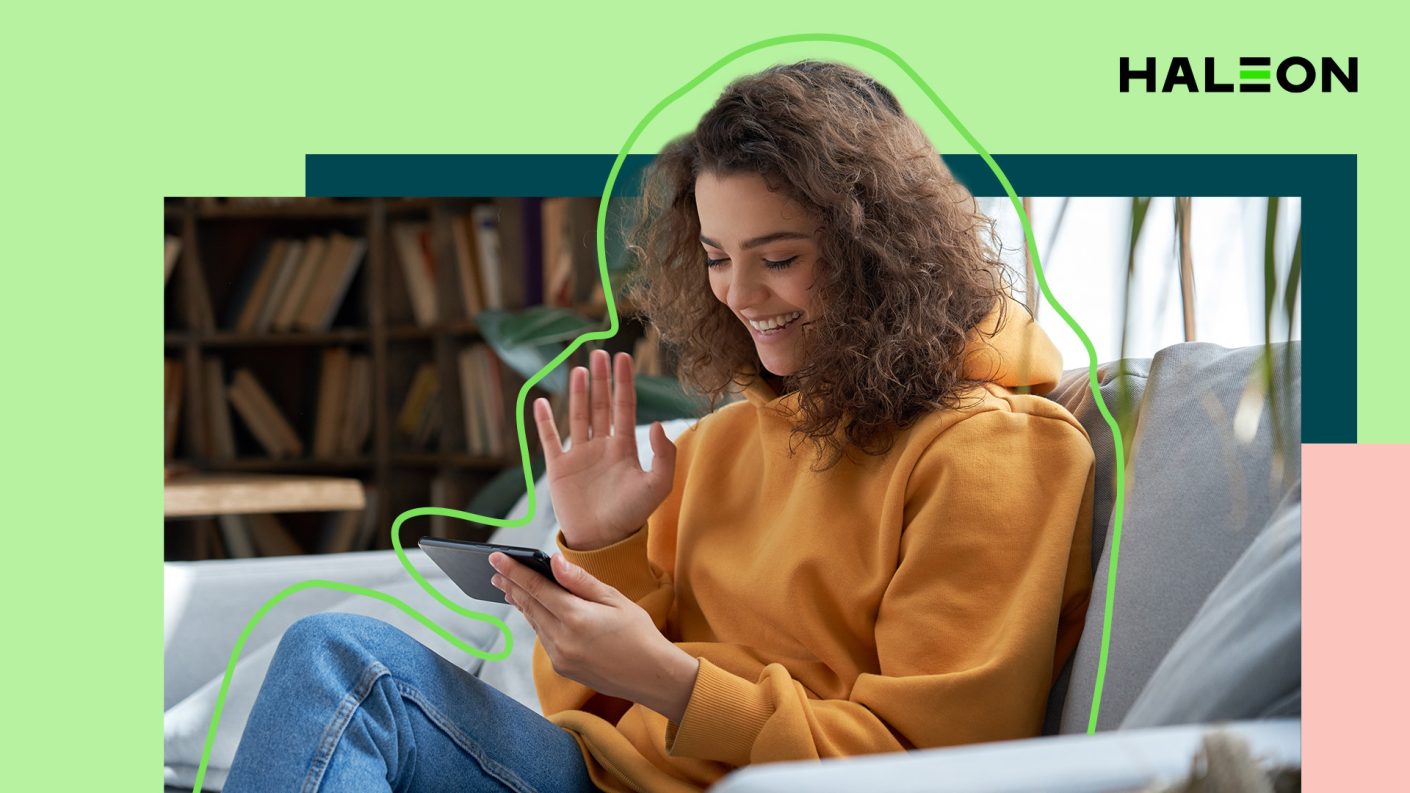 Woman waving at her smartphone