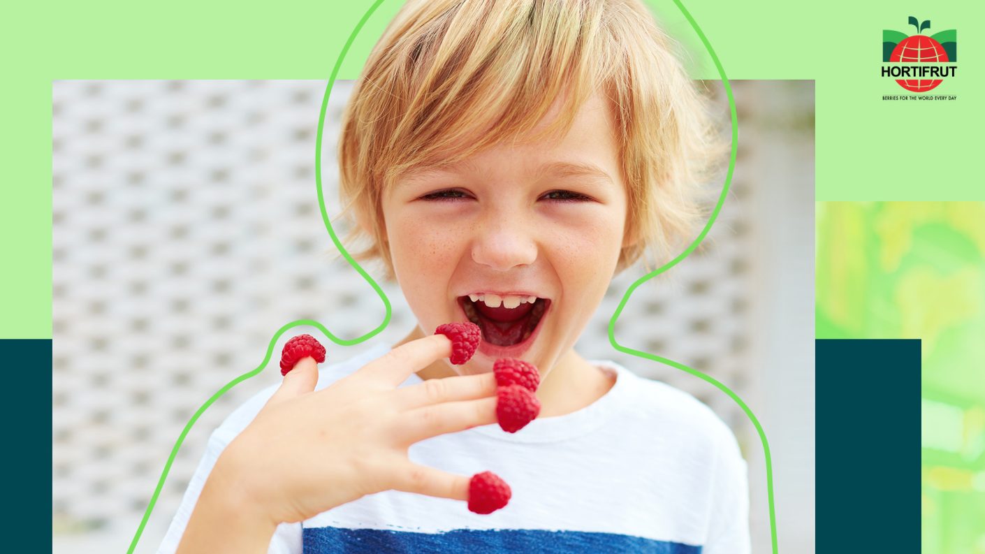 Child with raspberries on top of his fingers