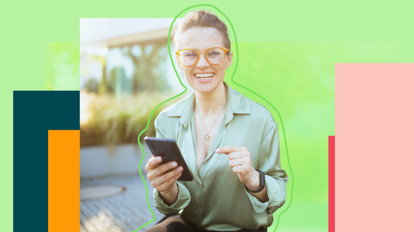 Woman holding smartphone in her hand, smiling