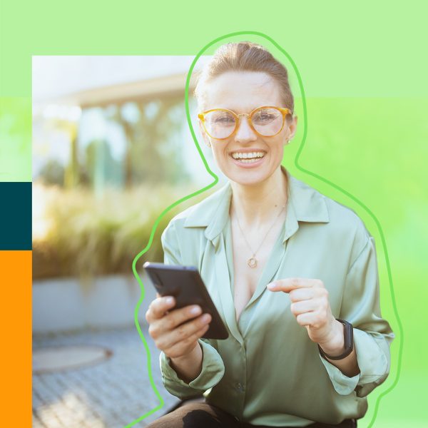 Woman holding smartphone in her hand, smiling