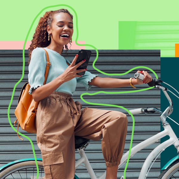 Woman on a bike, looking at her phone