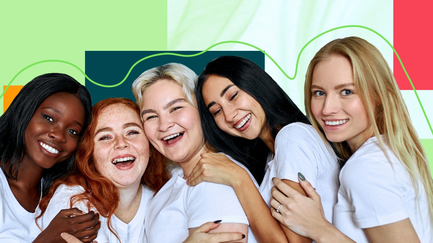 women holding each other and laughing