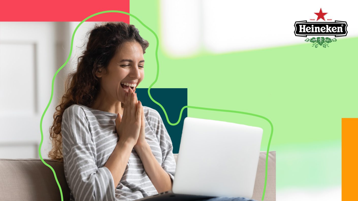 Woman sitting enthusiastic behind her computer