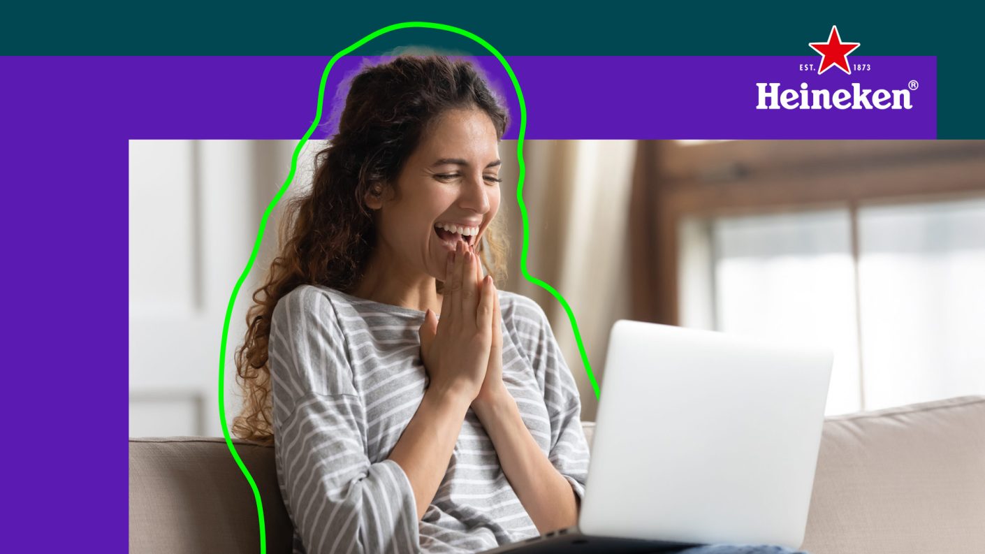 Woman sitting enthusiastic behind her computer