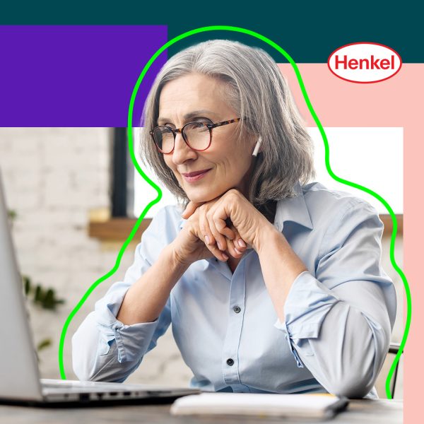 Woman with grey hair looking at her open laptop