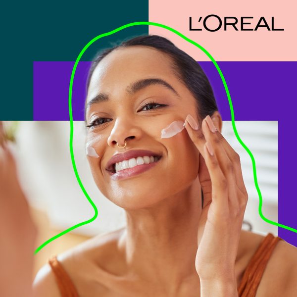 A woman is wiping cream on her face.