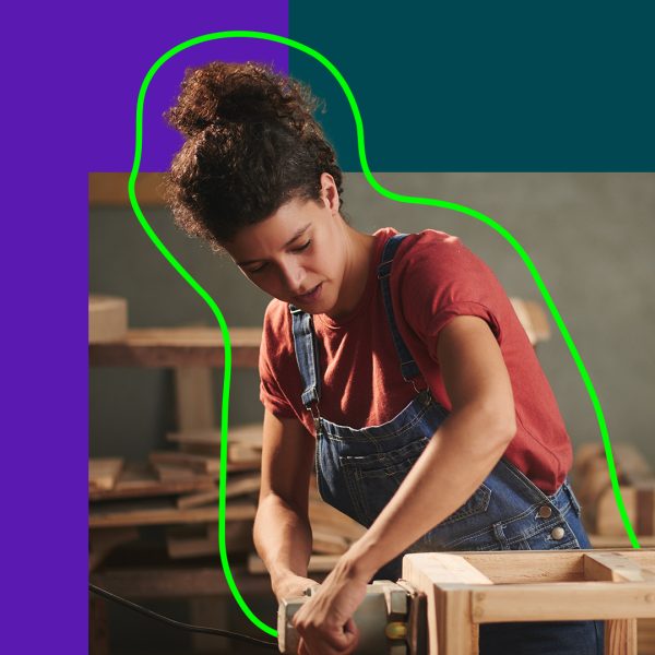 Woman making a chair in wood
