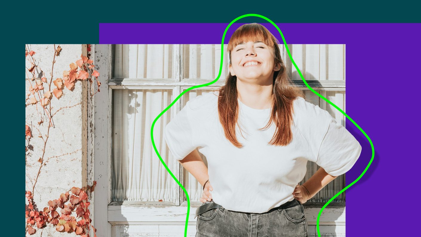 Woman smiling at camera with eyes closed