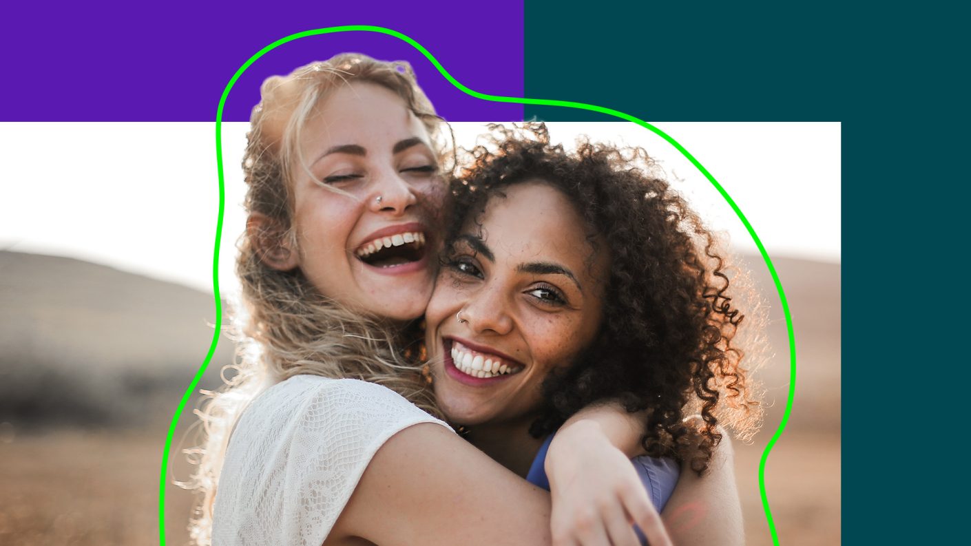 Two women hugging and smiling.