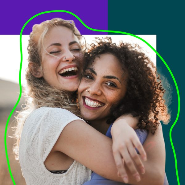 Two women hugging and smiling.