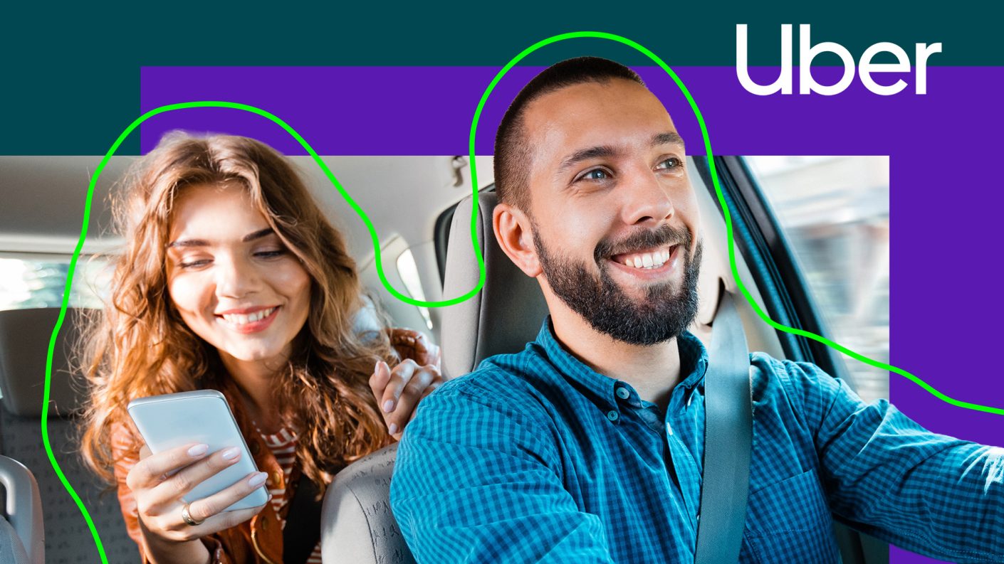 Woman in taxi on her phone with smiling chauffeur
