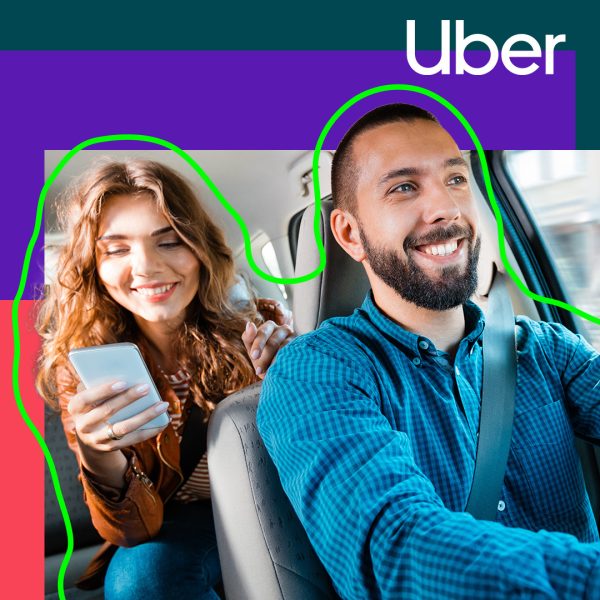 Woman in taxi on her phone with smiling chauffeur